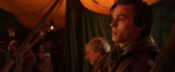 Movie still from “Jack the Giant Slayer” (2013), directed by Bryan Singer – A man standing next to another man in front of a tent; Close Up shot, Over the shoulder angle