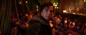 Movie still from “Jack the Giant Slayer” (2013), directed by Bryan Singer – A man in a brown jacket standing next to a crowd; Close Up shot, Over the shoulder angle
