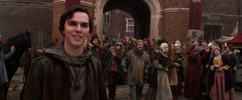 Movie still from “Jack the Giant Slayer” (2013), directed by Bryan Singer – A group of people walking down a street; Medium shot, Over the shoulder angle