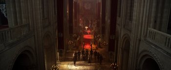 Movie still from “Jack the Giant Slayer” (2013), directed by Bryan Singer – A group of people standing in a large room; Extreme Wide shot, High angle