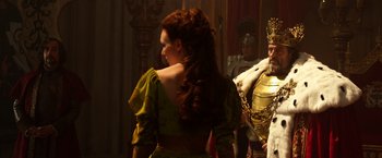 Movie still from “Jack the Giant Slayer” (2013), directed by Bryan Singer – A woman with long red hair standing next to a man in armor; Medium shot, Over the shoulder angle