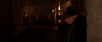 Movie still from “Jack the Giant Slayer” (2013), directed by Bryan Singer – A person wearing a hat in a dark room; Medium shot, Over the shoulder angle