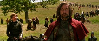 Movie still from “Jack the Giant Slayer” (2013), directed by Bryan Singer – A man in medieval garb standing next to a horse; Medium shot, Over the shoulder angle
