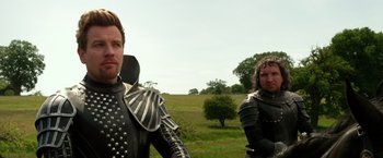 Movie still from “Jack the Giant Slayer” (2013), directed by Bryan Singer – Two men in medieval garb standing in a grassy field; Medium shot, Over the shoulder angle