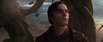 Movie still from “Jack the Giant Slayer” (2013), directed by Bryan Singer – A man looking up at a tree with clouds in the background; Close Up shot, Low angle