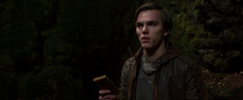 Movie still from “Jack the Giant Slayer” (2013), directed by Bryan Singer – A young man holding a piece of wood in his hand; Close Up shot, Low angle