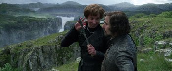 Movie still from “Jack the Giant Slayer” (2013), directed by Bryan Singer – A woman and a man are holding a pair of scissors; Medium shot, Over the shoulder angle