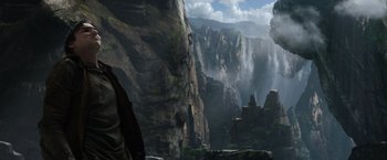 Movie still from “Jack the Giant Slayer” (2013), directed by Bryan Singer – A man standing on top of a cliff next to a waterfall; Extreme Wide shot, Low angle