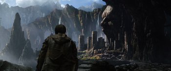 Movie still from “Jack the Giant Slayer” (2013), directed by Bryan Singer – A man standing in front of a large waterfall; Extreme Wide shot, Over the shoulder angle