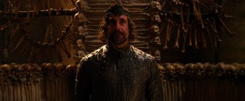 Movie still from “Jack the Giant Slayer” (2013), directed by Bryan Singer – A man wearing a leather outfit and a crown; Medium shot, Low angle