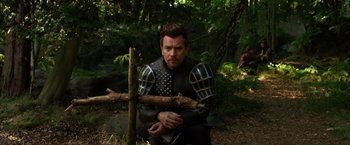 Movie still from “Jack the Giant Slayer” (2013), directed by Bryan Singer – A man dressed as a medieval knight holding a stick; Medium shot, Over the shoulder angle