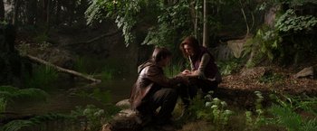 Movie still from “Jack the Giant Slayer” (2013), directed by Bryan Singer – A man kneeling down next to a woman in the woods; Wide shot, High angle