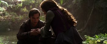 Movie still from “Jack the Giant Slayer” (2013), directed by Bryan Singer – A man and a woman sitting on the ground in a forest; Medium shot, High angle