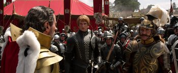 Movie still from “Jack the Giant Slayer” (2013), directed by Bryan Singer – A group of people in medieval costumes with swords; Medium shot, Over the shoulder angle