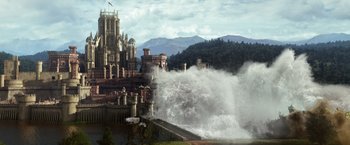 Movie still from “Jack the Giant Slayer” (2013), directed by Bryan Singer – A castle is being blown by the water from a lake; Extreme Wide shot, Low angle