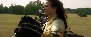 Movie still from “Jack the Giant Slayer” (2013), directed by Bryan Singer – A woman dressed as a medieval knight on horseback; Medium shot, Over the shoulder angle
