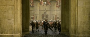 Movie still from “Jack the Giant Slayer” (2013), directed by Bryan Singer – A group of people are walking through a courtyard; Wide shot, High angle