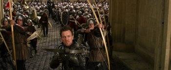 Movie still from “Jack the Giant Slayer” (2013), directed by Bryan Singer – A group of men in medieval costumes holding arrows; Medium shot, Over the shoulder angle