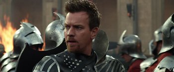 Movie still from “Jack the Giant Slayer” (2013), directed by Bryan Singer – A person wearing armor and a helmet; Close Up shot, Over the shoulder angle