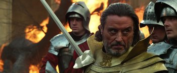 Movie still from “Jack the Giant Slayer” (2013), directed by Bryan Singer – A person holding a sword near another person; Close Up shot, Over the shoulder angle