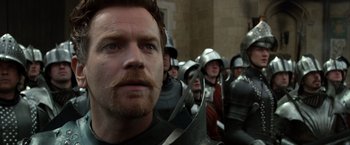 Movie still from “Jack the Giant Slayer” (2013), directed by Bryan Singer – A person in a crowd of people; Close Up shot, Over the shoulder angle