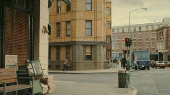 Movie still from “Jackass Forever” (2022), directed by Jeff Tremaine – A man running across the street in front of a tall building; Extreme Wide shot, Over the shoulder angle
