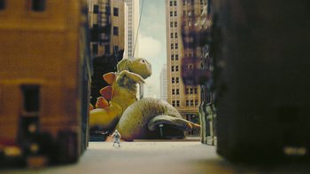 Movie still from “Jackass Forever” (2022), directed by Jeff Tremaine – An inflatable dinosaur is sitting in the middle of the street; Extreme Wide shot, High angle