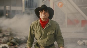 Movie still from “Jackass Forever” (2022), directed by Jeff Tremaine – An older man wearing a cowboy hat and glasses; Medium shot, Low angle