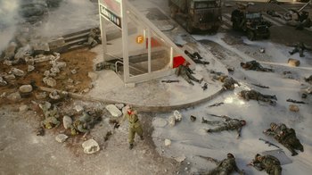 Movie still from “Jackass Forever” (2022), directed by Jeff Tremaine – A group of soldiers laying on the ground next to a bus stop; Extreme Wide shot, High angle