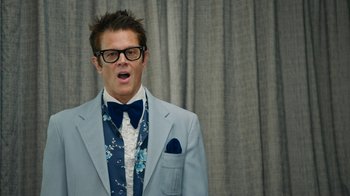 Movie still from “Jackass Forever” (2022), directed by Jeff Tremaine – A man in a blue suit and bow tie; Close Up shot, Low angle