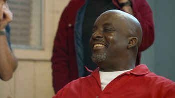 Movie still from “Jackass Forever” (2022), directed by Jeff Tremaine – A man in a red shirt is smiling; Close Up shot, High angle