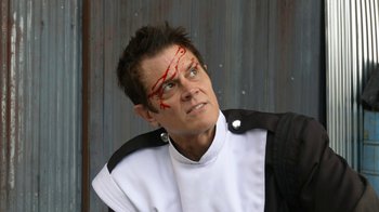 Movie still from “Jackass Forever” (2022), directed by Jeff Tremaine – A man with a scar on his face and a scar on his forehead; Close Up shot, Low angle
