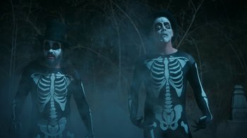Movie still from “Jackass Forever” (2022), directed by Jeff Tremaine – A couple of men dressed up like skeletons; Medium shot, Low angle