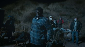 Movie still from “Jackass Forever” (2022), directed by Jeff Tremaine – A group of people standing in a dark area; Medium shot, Low angle