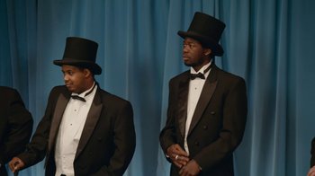 Movie still from “Jackass Forever” (2022), directed by Jeff Tremaine – A couple of men in tuxedos standing next to each other; Medium shot, Low angle