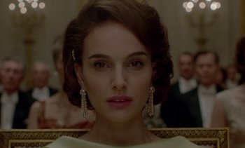 Movie still from “Jackie” (2016), directed by Pablo Larraín – A person wearing a white dress; Close Up shot, Over the shoulder angle