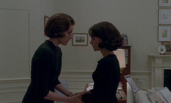Movie still from “Jackie” (2016), directed by Pablo Larraín – Two women standing next to each other in a room; Medium shot, Over the shoulder angle