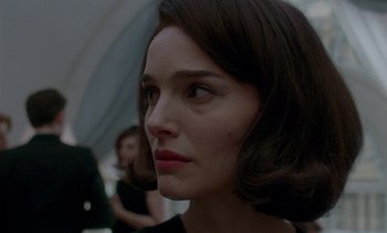 Movie still from “Jackie” (2016), directed by Pablo Larraín – A person wearing a black dress; Close Up shot, Over the shoulder angle