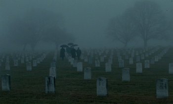 Movie still from “Jackie” (2016), directed by Pablo Larraín – People walking through a cemetery on a foggy day; Extreme Wide shot, High angle