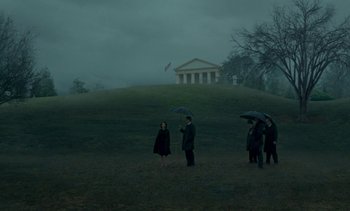 Movie still from “Jackie” (2016), directed by Pablo Larraín – A group of people standing on top of a grass covered hill; Extreme Wide shot, Low angle