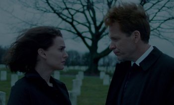 Movie still from “Jackie” (2016), directed by Pablo Larraín – A man and a woman standing next to each other in a cemetery; Close Up shot, Over the shoulder angle