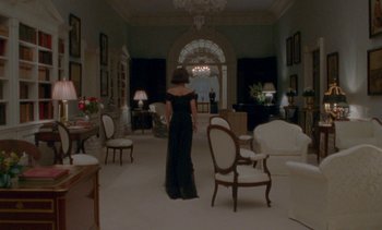 Movie still from “Jackie” (2016), directed by Pablo Larraín – A woman in a black dress in a living room; Wide shot, High angle