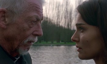 Movie still from “Jackie” (2016), directed by Pablo Larraín – An older man and a younger woman face to face; Close Up shot, Over the shoulder angle