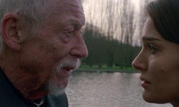 Movie still from “Jackie” (2016), directed by Pablo Larraín – An older man and a younger woman face to face; Close Up shot, Over the shoulder angle