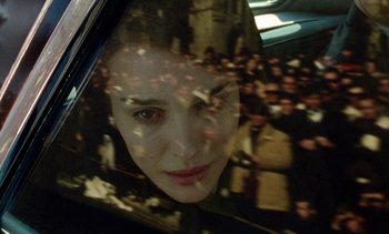 Movie still from “Jackie” (2016), directed by Pablo Larraín – A person's face through a car window; Extreme Close Up shot, High angle