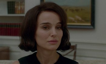 Movie still from “Jackie” (2016), directed by Pablo Larraín – A person wearing a black shirt; Close Up shot, Over the shoulder angle