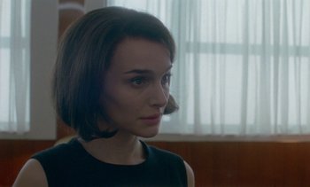 Movie still from “Jackie” (2016), directed by Pablo Larraín – A person wearing a black shirt; Close Up shot, Over the shoulder angle