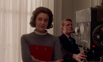 Movie still from “Jackie” (2016), directed by Pablo Larraín – A man and a woman standing next to each other in a room; Medium shot, Low angle