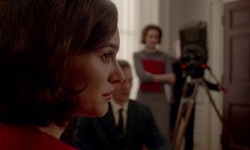 Movie still from “Jackie” (2016), directed by Pablo Larraín – A person in a room near a camera; Close Up shot, Over the shoulder angle