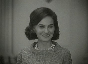 Movie still from “Jackie” (2016), directed by Pablo Larraín – An old photo of a woman in a sweater; Close Up shot, Over the shoulder angle